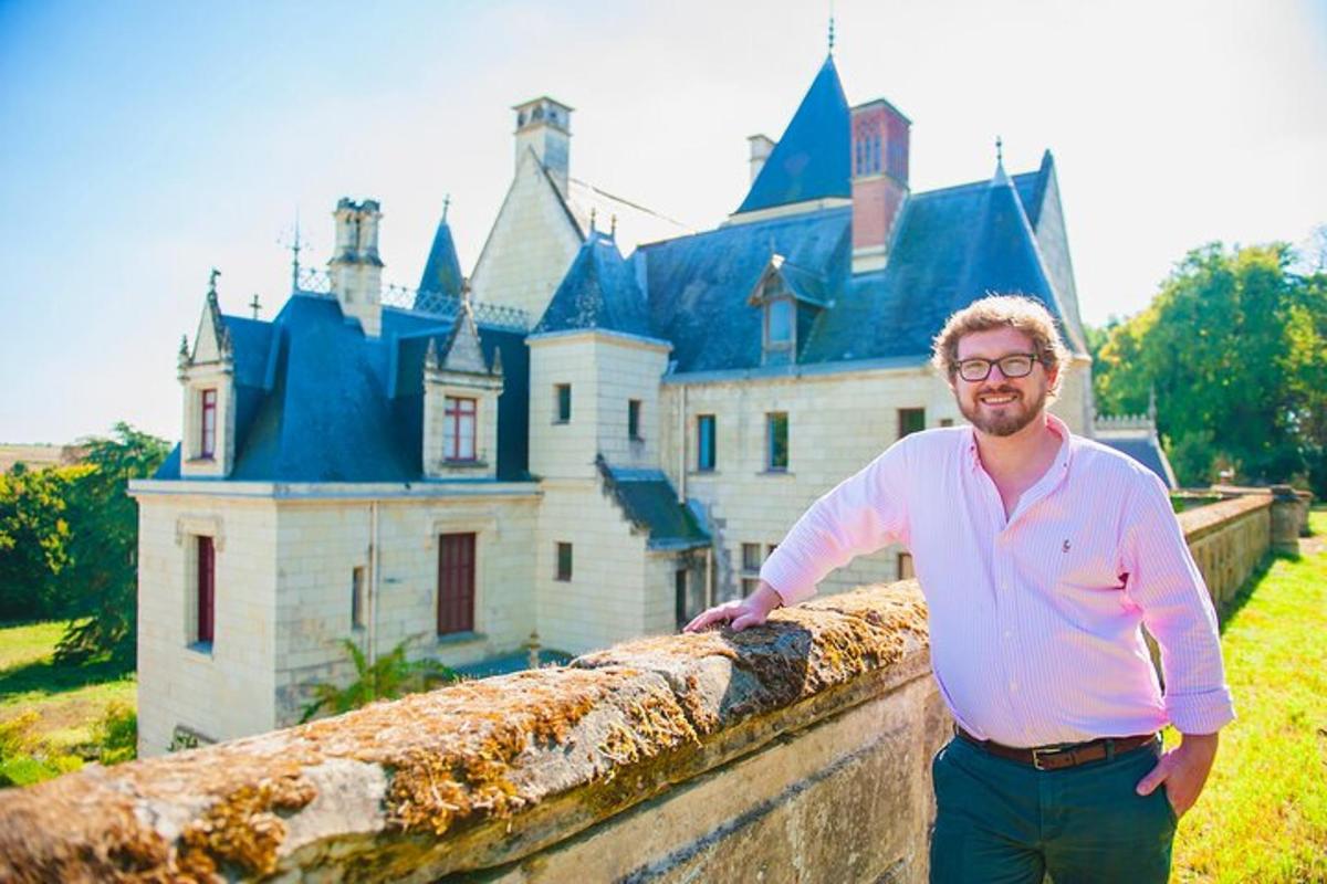 a man leaning against a wall in front of a castle