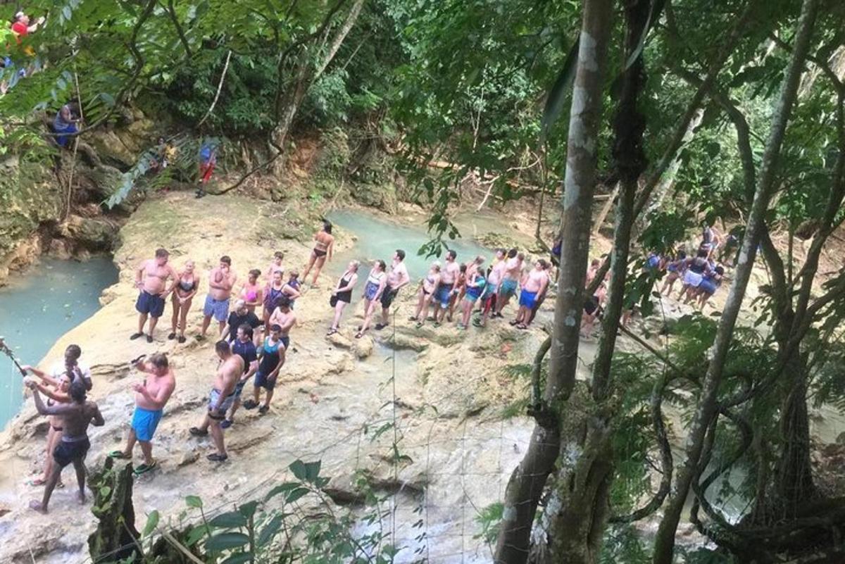 Un grupo de personas de pie en una playa cerca de un río.