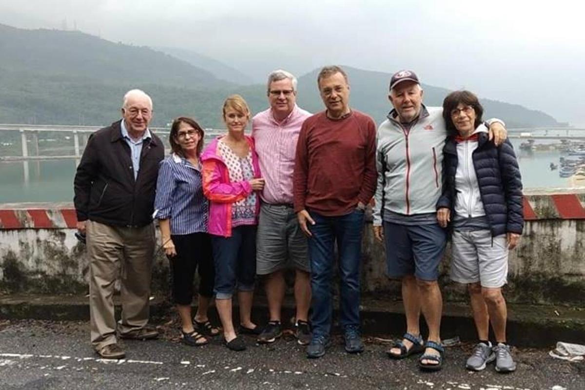 um grupo de pessoas posando para uma foto em uma ponte