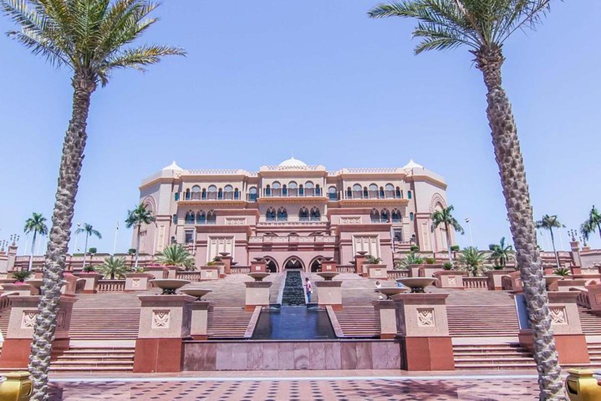 a large building with palm trees in front of it