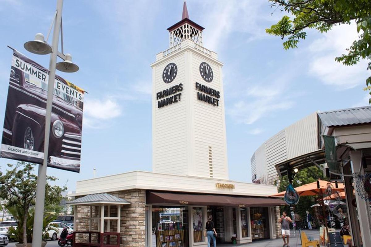 a clock tower on top of a shopping center