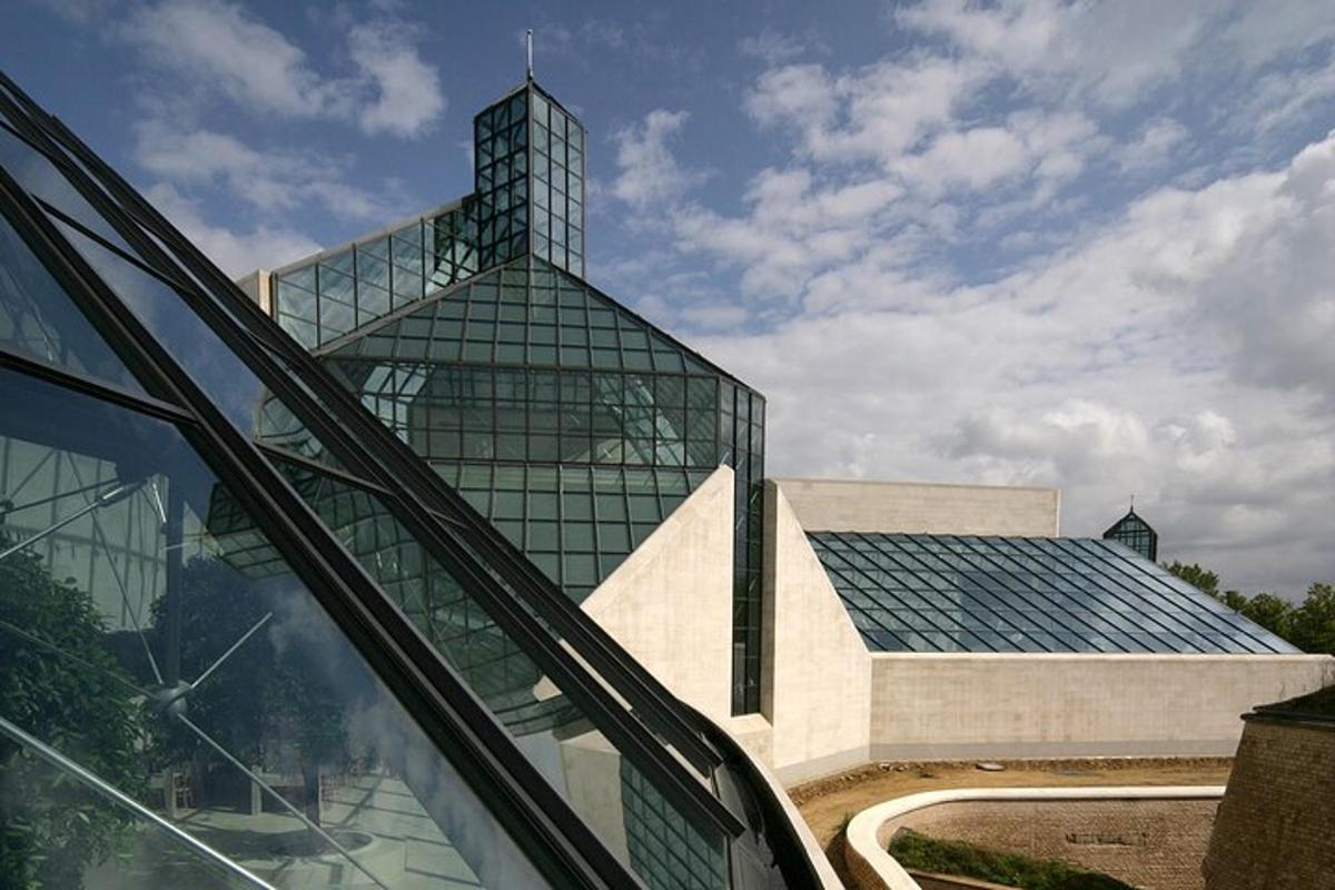a large glass building with a tower on top of it