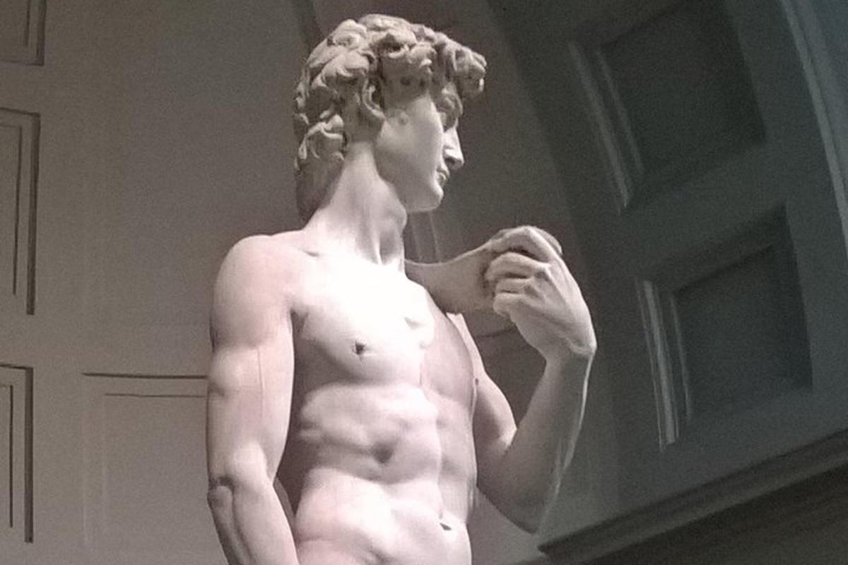 o statuie a unei femei goale care stă într-o cameră