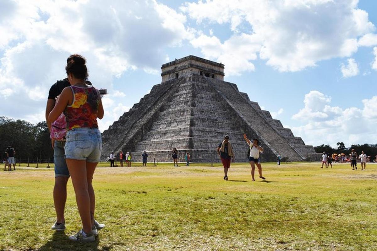 a group of people standing in front of a pyramid