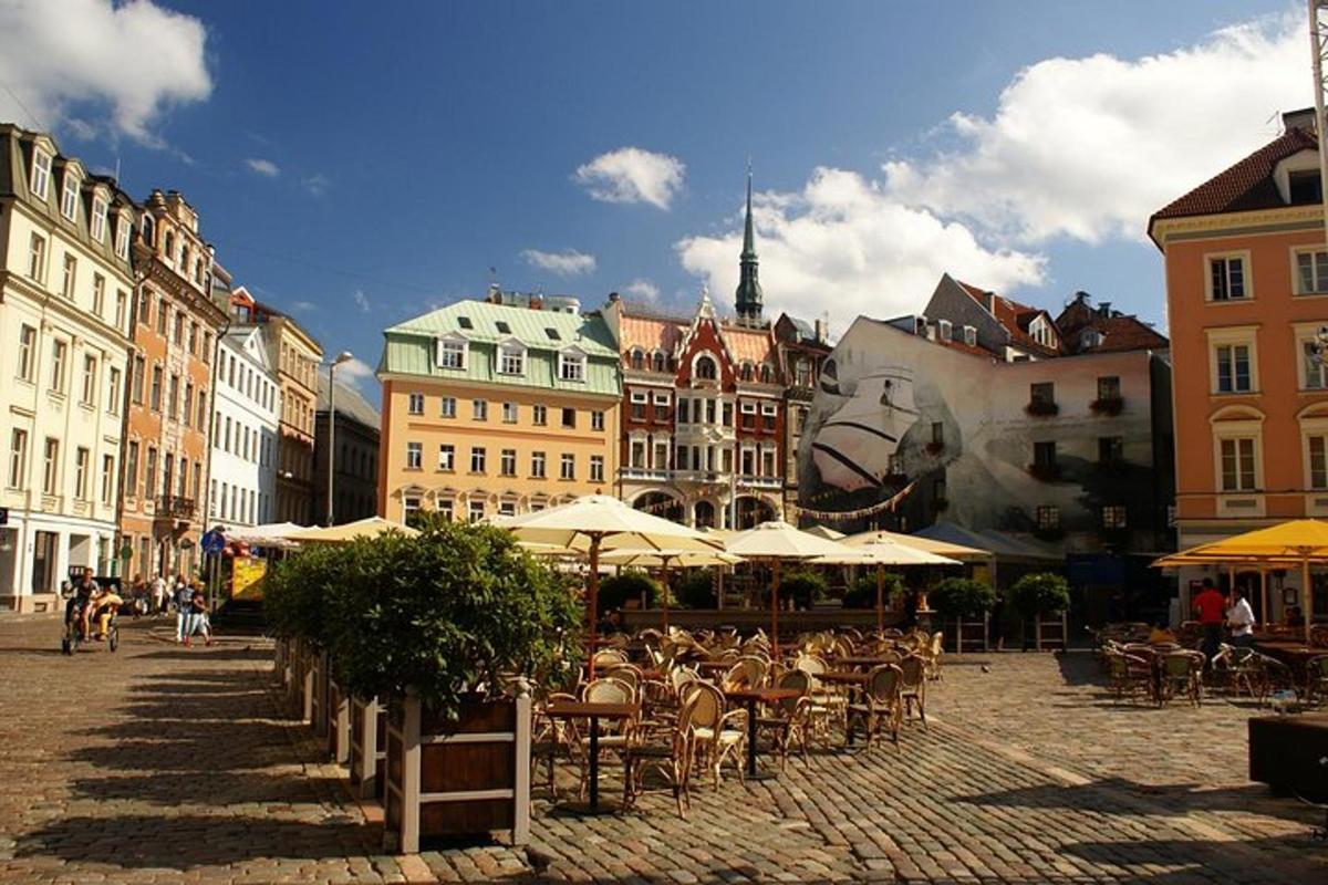 a city street with tables and chairs and buildings
