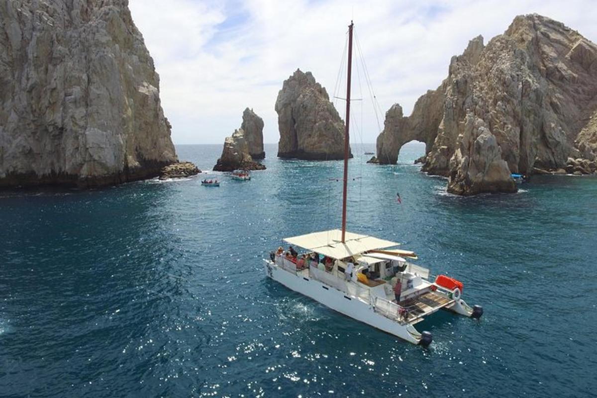 a boat in the water near some rocks