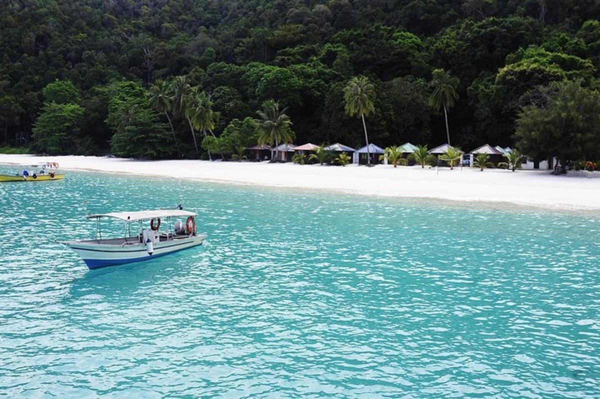a boat in the water next to a beach