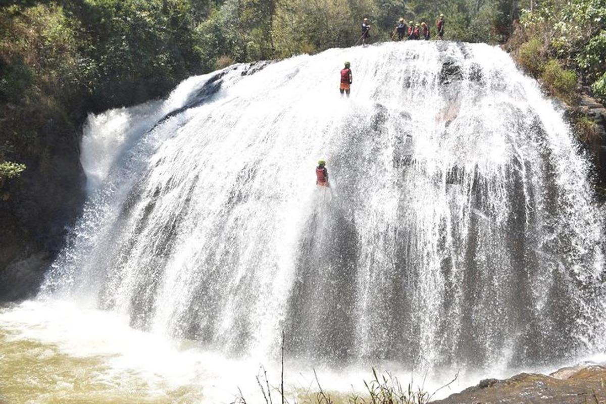 a group of people standing on top of a waterfall