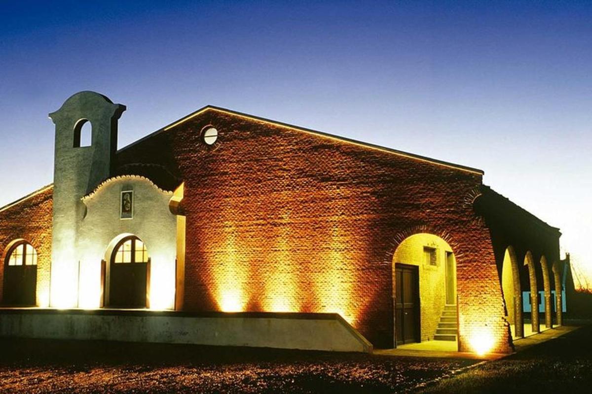 a brick church with lights on the side of it