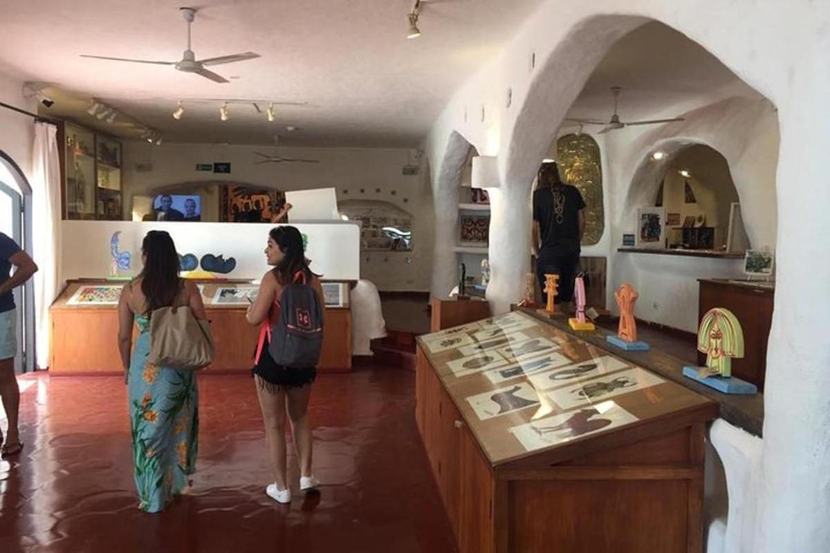 two women are standing in a room with a counter