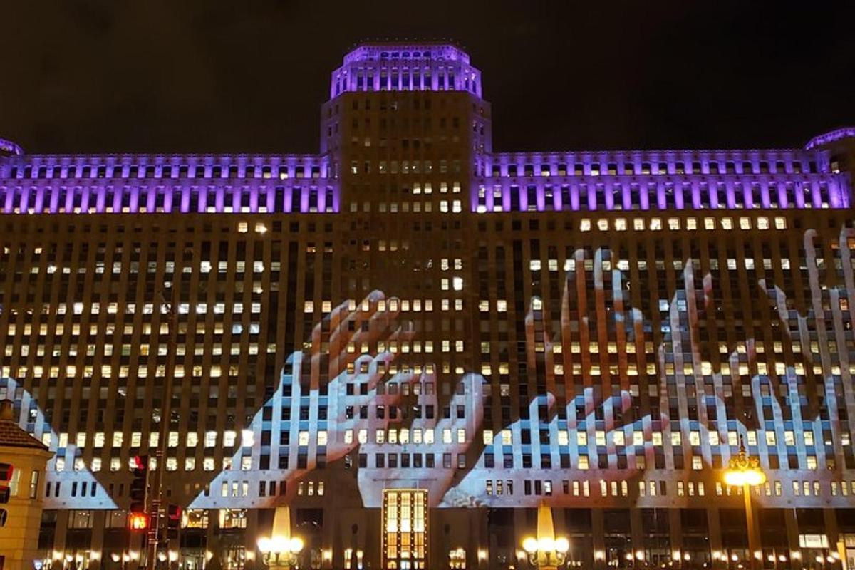 a large building is lit up with purple lights