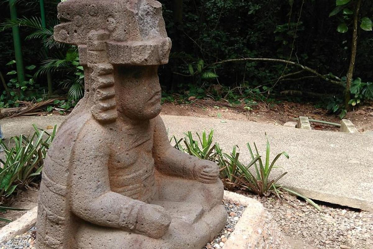a stone statue of a child in a garden