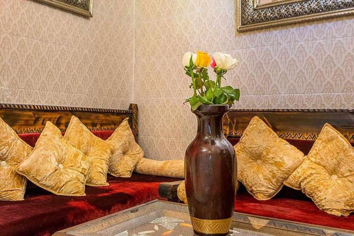 a vase with roses in it sitting on a couch