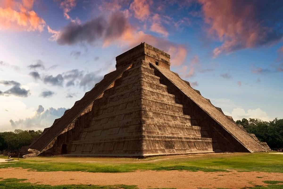 a pyramid with a cloudy sky in the background