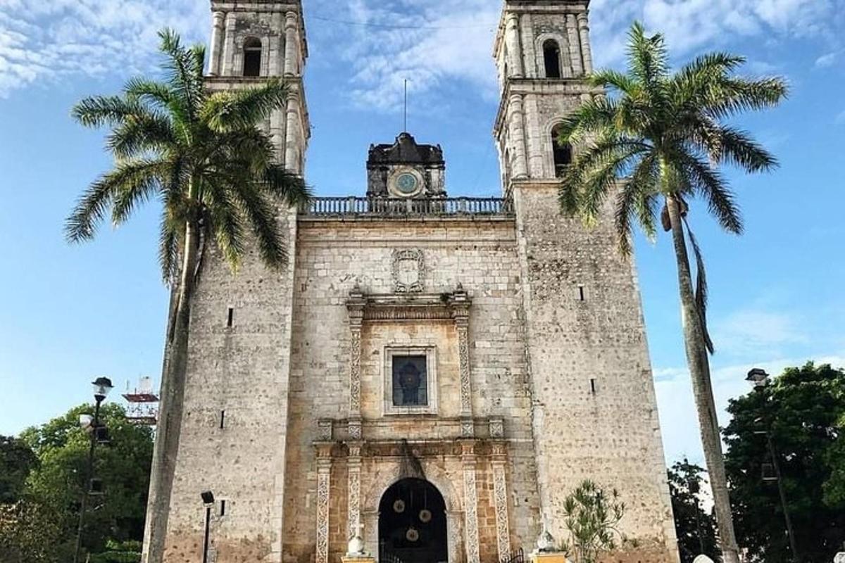 a building with a clock tower and two palm trees