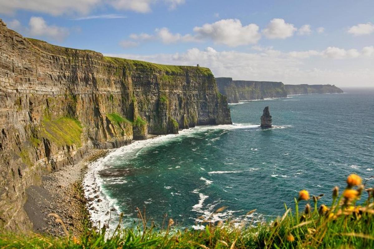 a view of the ocean with a rock formation