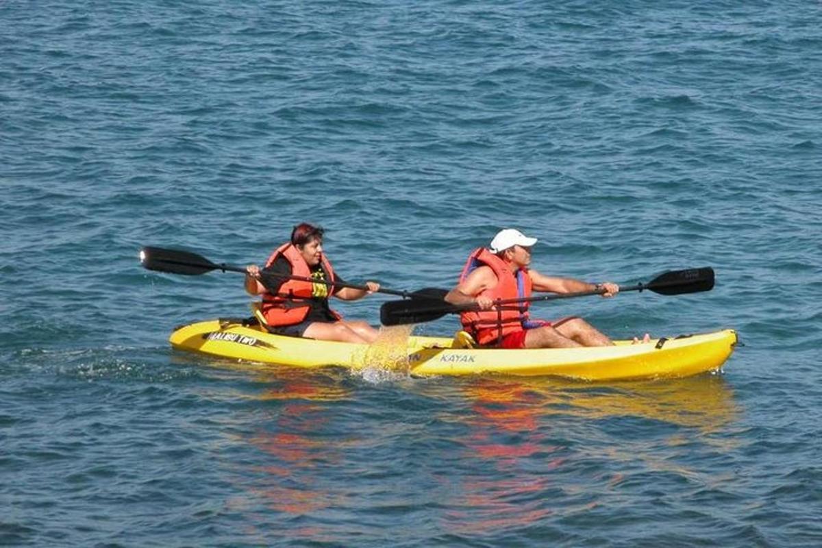 two people in a yellow kayak in the water