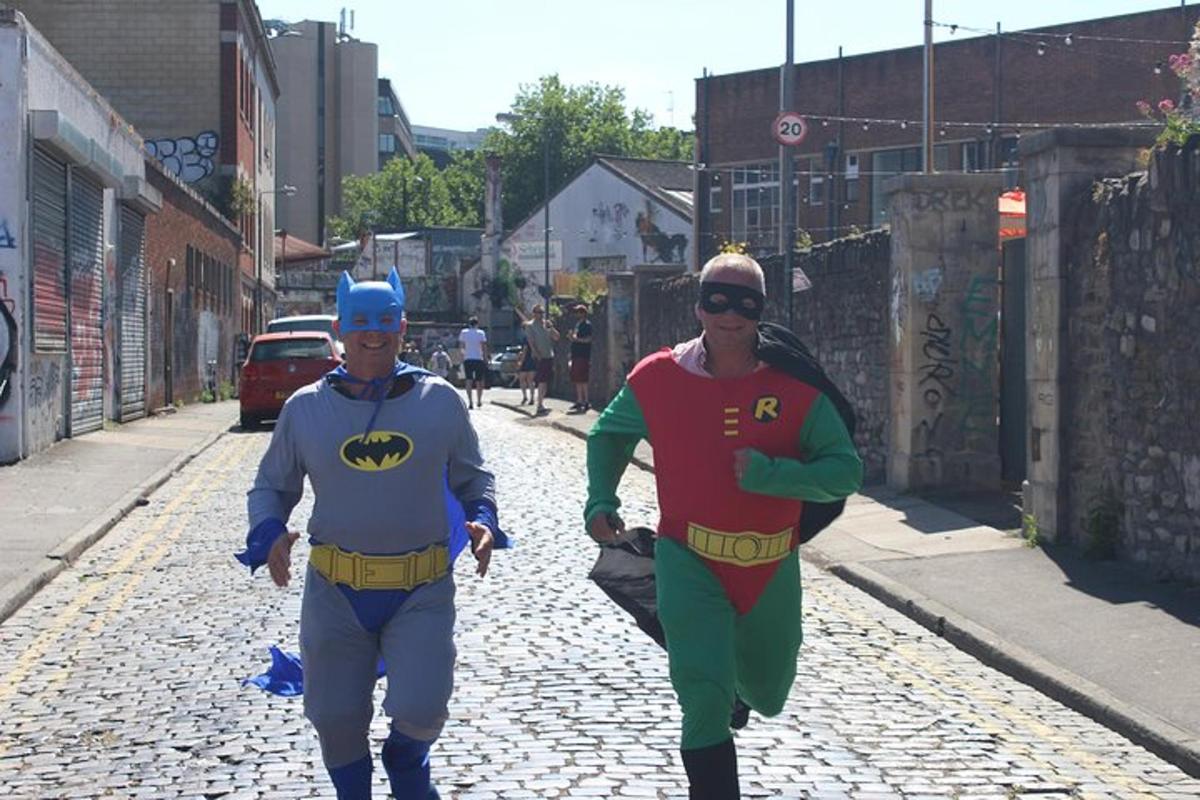 Dos hombres con disfraces de superhéroes caminando por una calle