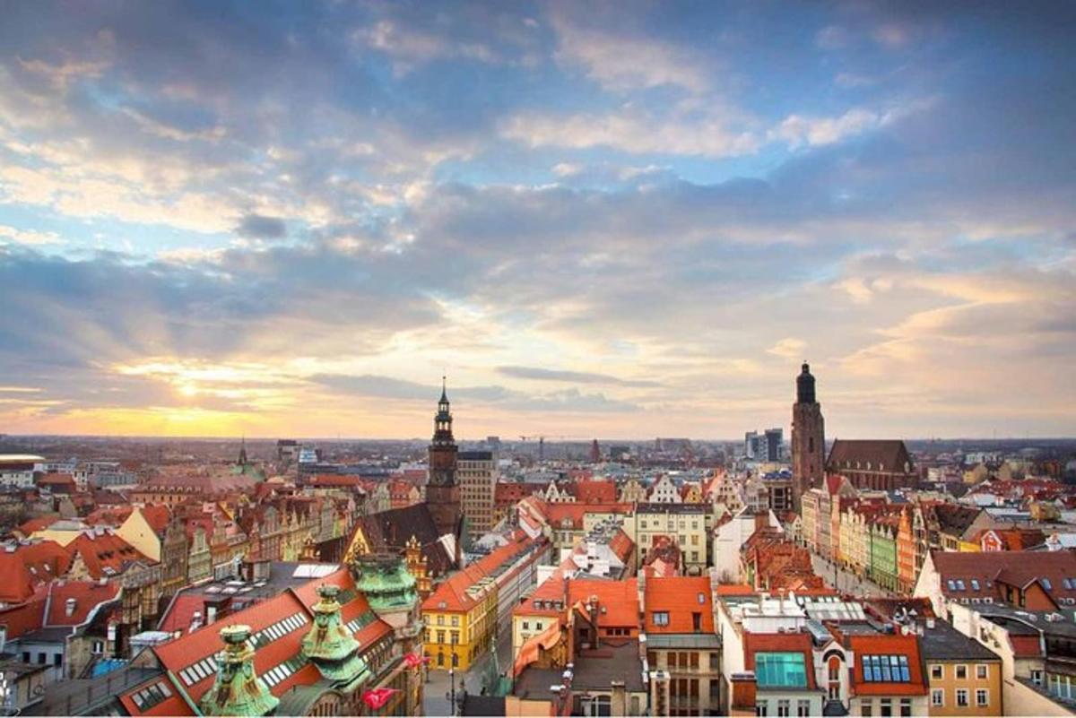 a view of a city with buildings and a cloudy sky