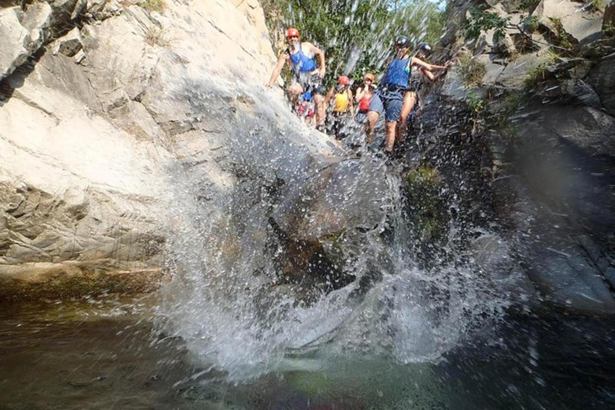 a group of people riding an elephant in the water