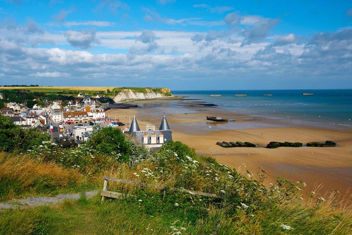 a view of a beach with a town and the ocean