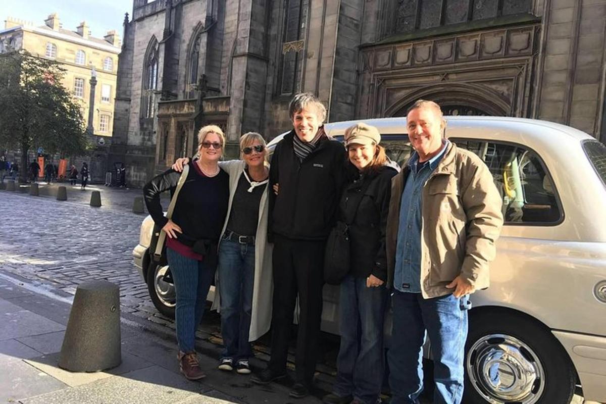 a group of people standing in front of a car