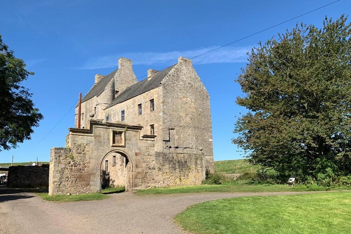 an old stone building on the side of a road