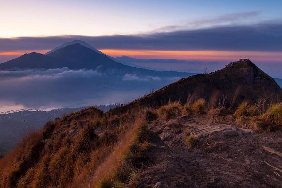 a view of a mountain at sunset with a mountain