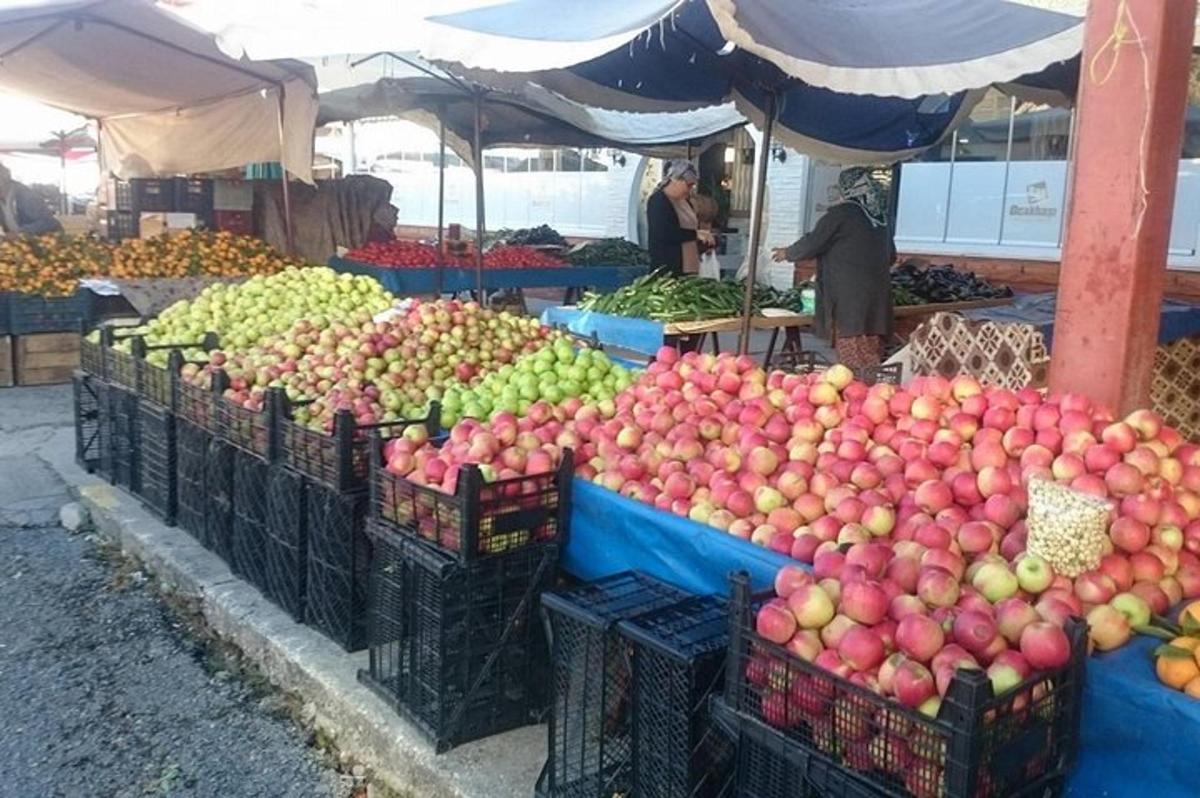 trh s mnoha košíky jablek a jiného ovoce