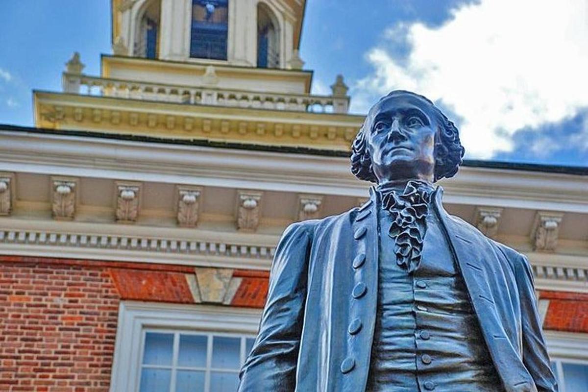 a statue of a man in front of a building