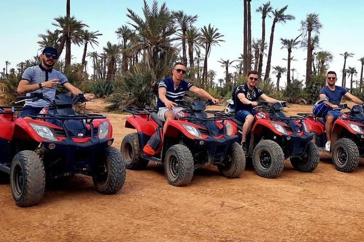 a group of men riding atvs on a dirt field