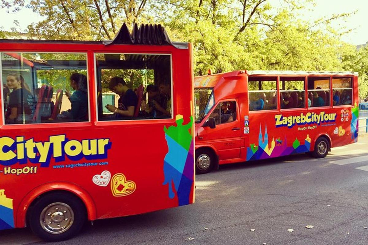 dois ônibus vermelhos estacionados um ao lado do outro em uma rua