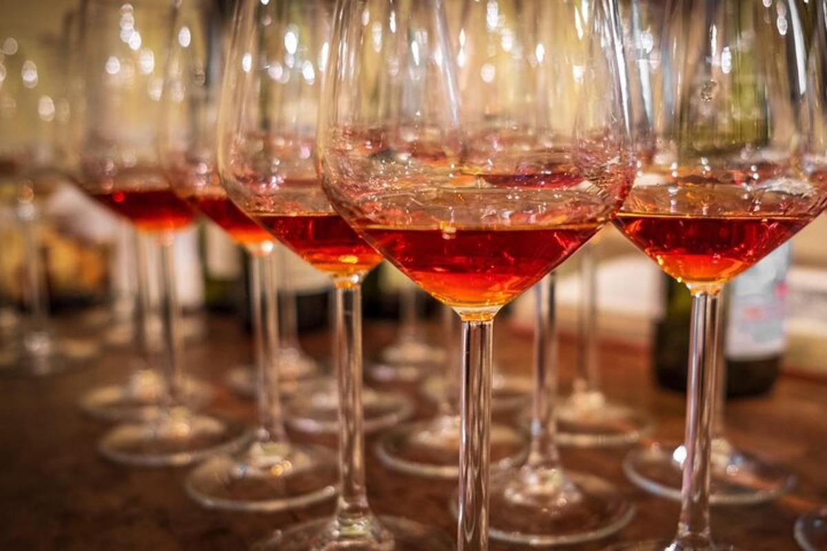 a row of wine glasses sitting on a table