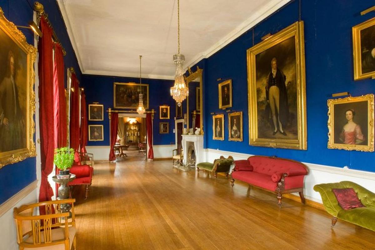a living room with blue walls and red furniture