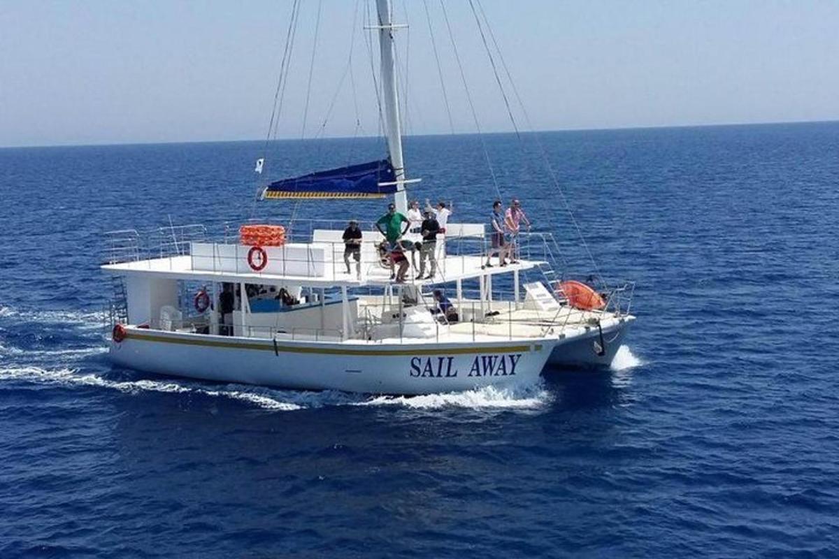 a group of people on a sail boat in the ocean