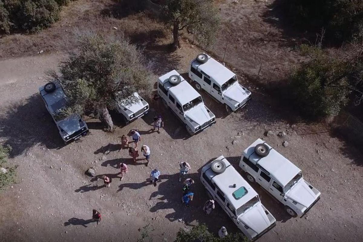an overhead view of three trucks parked in a field