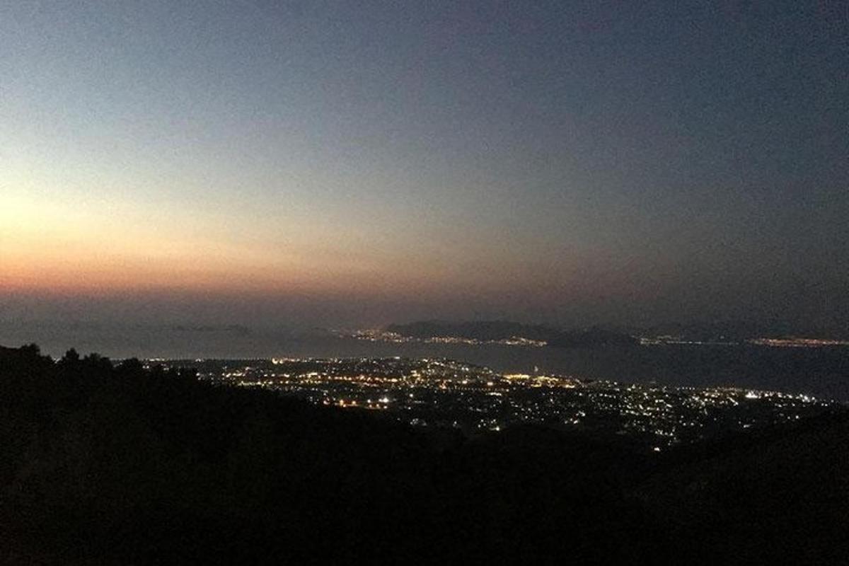 a view of a city from a hill at night