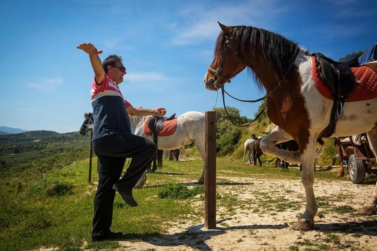 a man is standing next to a horse