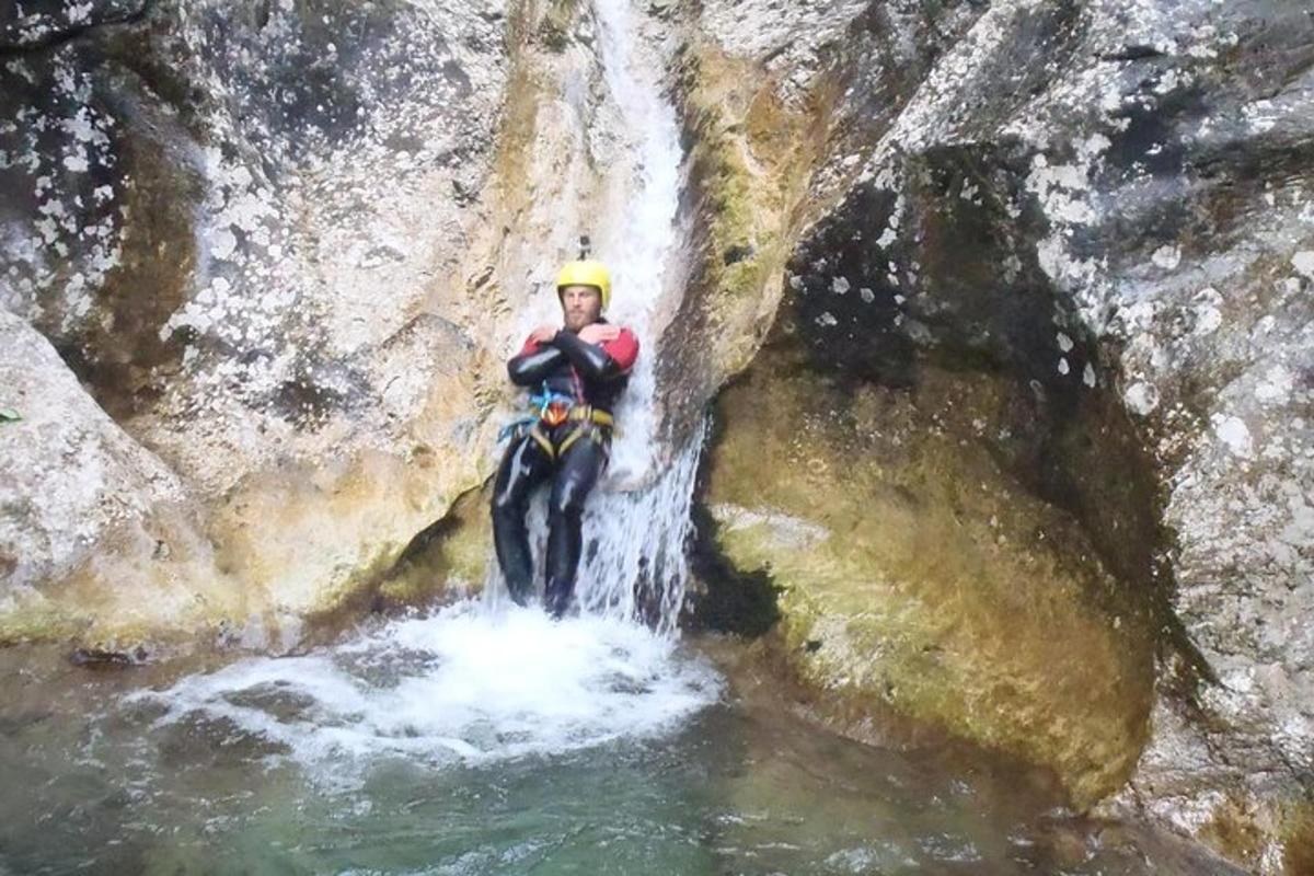 a man is standing in front of a waterfall
