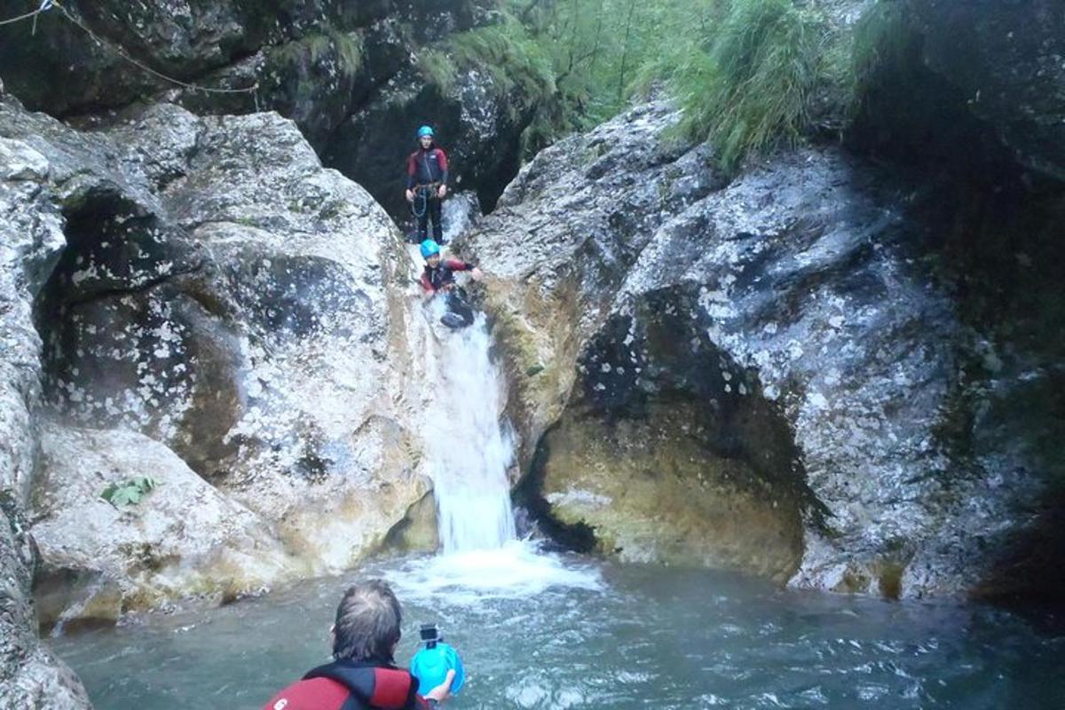 a group of people standing in front of a waterfall