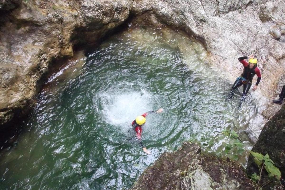 two people in the water in a cave