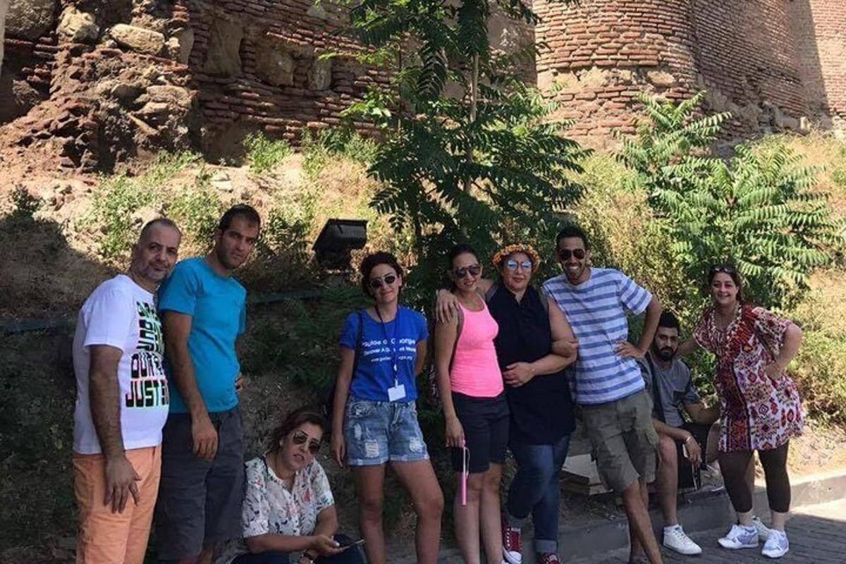 um grupo de pessoas posando para uma foto em frente a um castelo