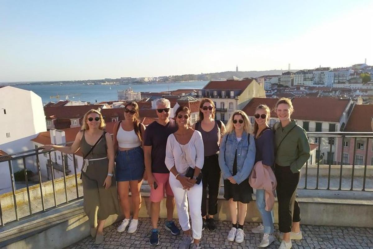 a group of people posing for a picture on a balcony