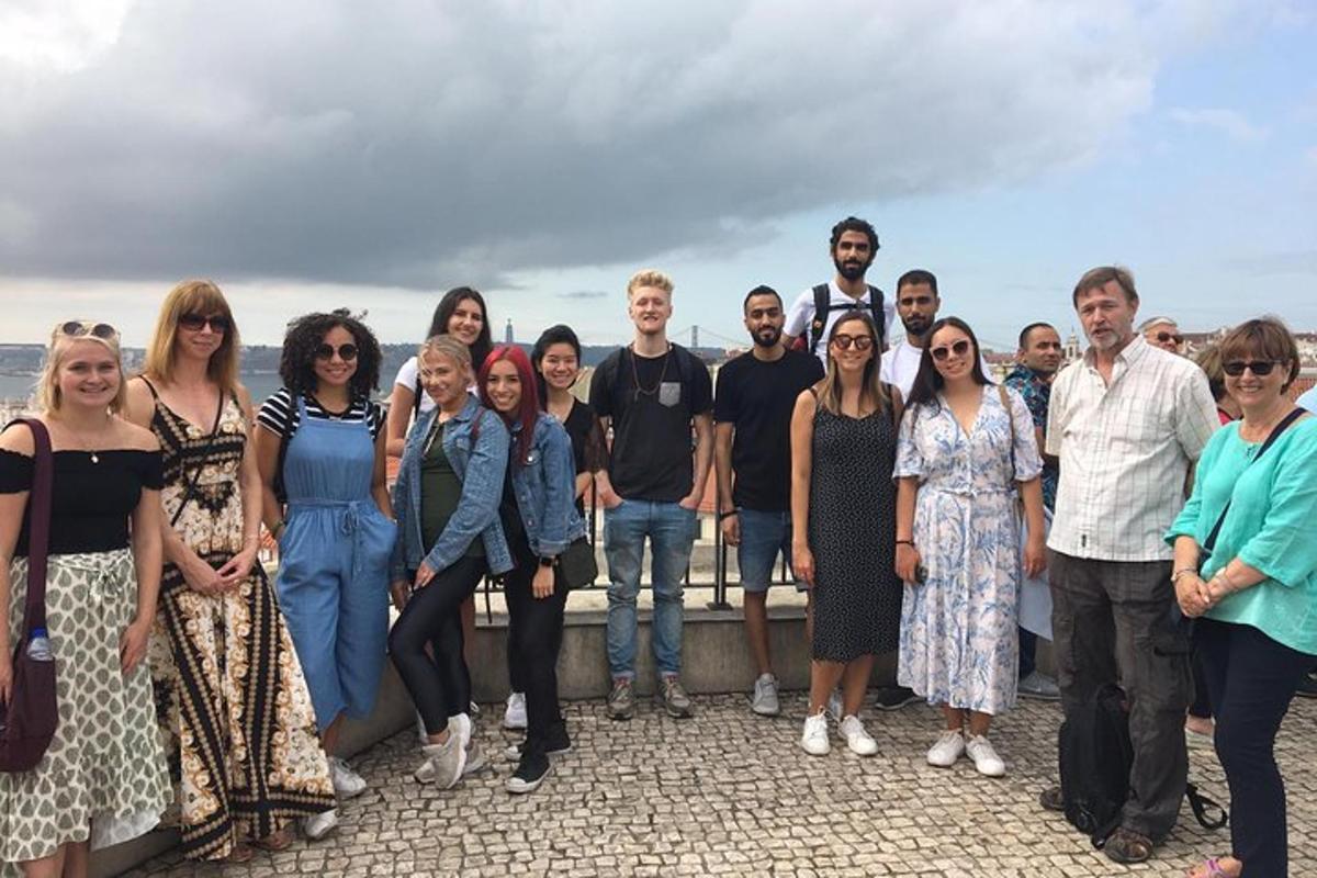 a group of people posing for a picture on a fence