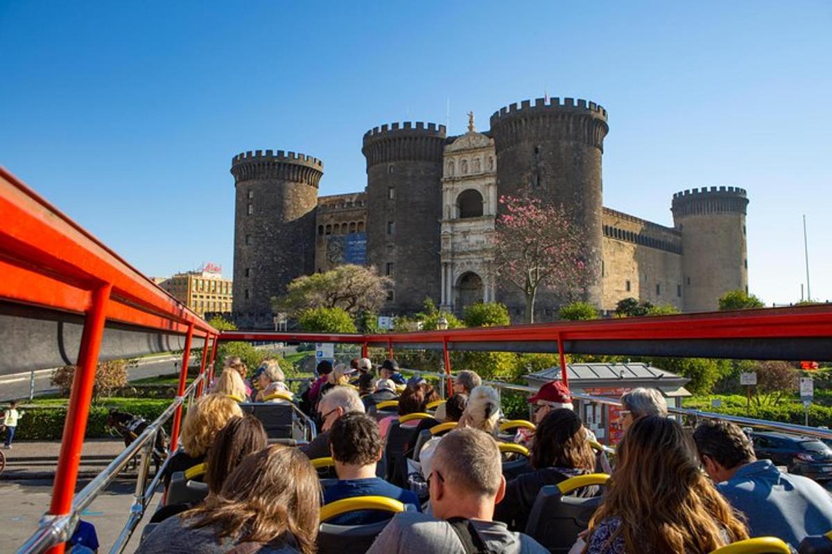 a group of people on a bus in front of a castle
