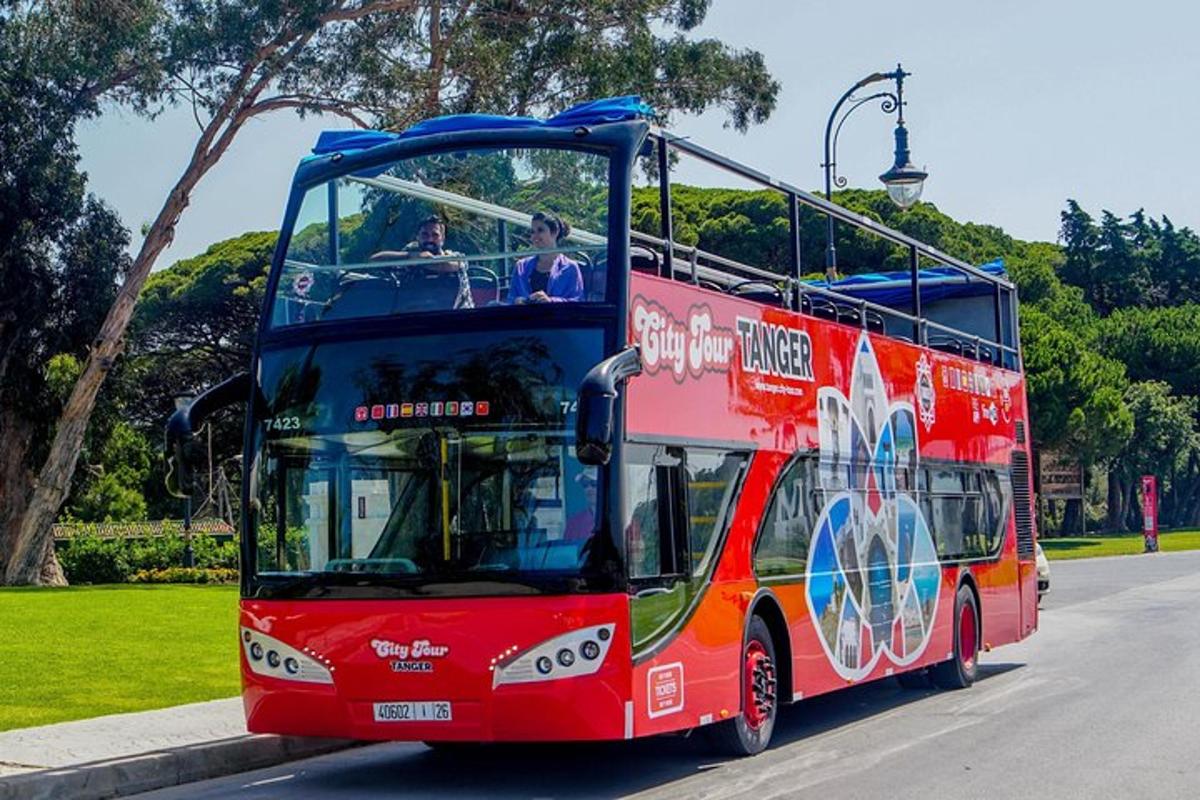 a red double decker bus driving down a street
