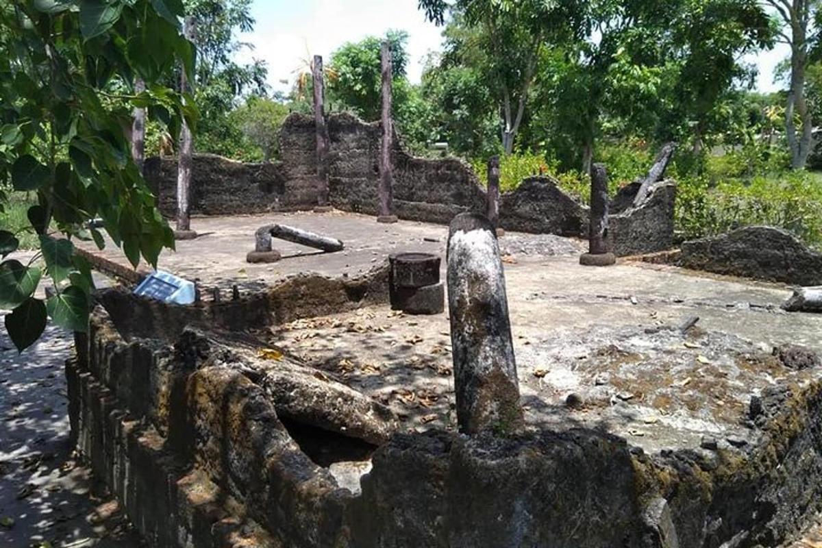 a stone wall with a courtyard in a park