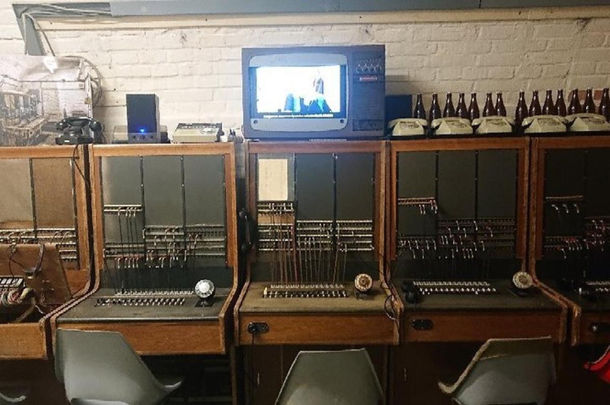 a television sitting on top of a room with chairs