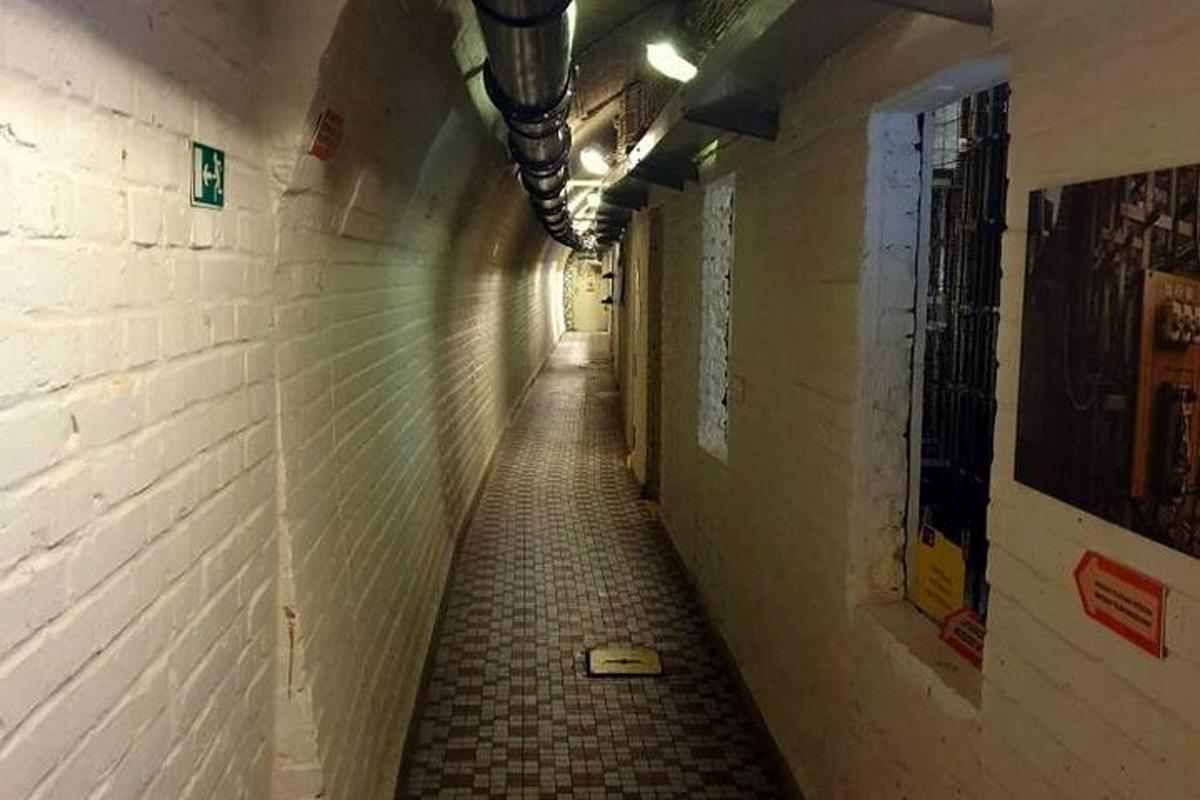 a long hallway with a tile floor in an alley