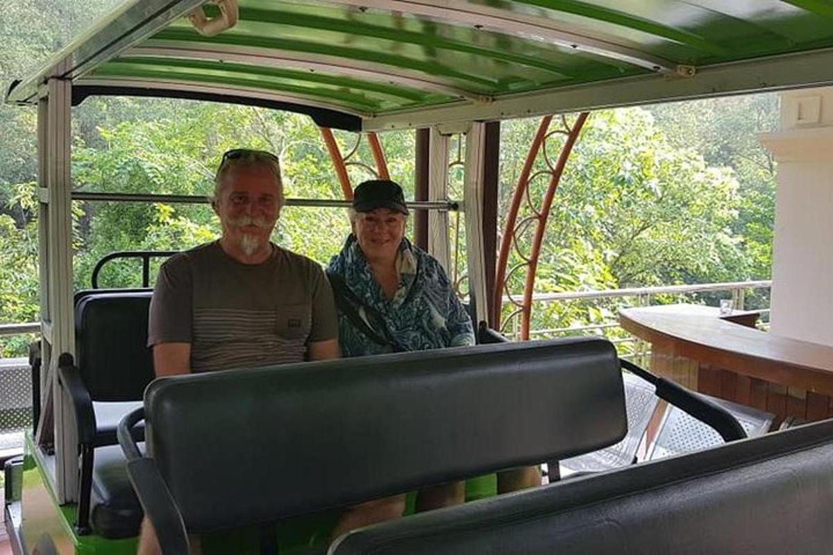 two people sitting in the back of a golf cart